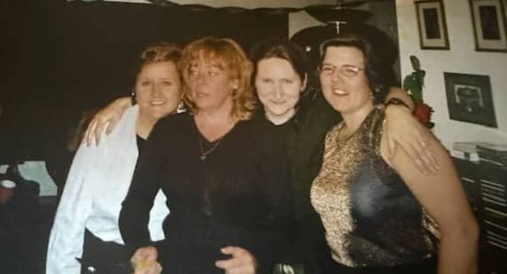 4 women friends smiling for the camera