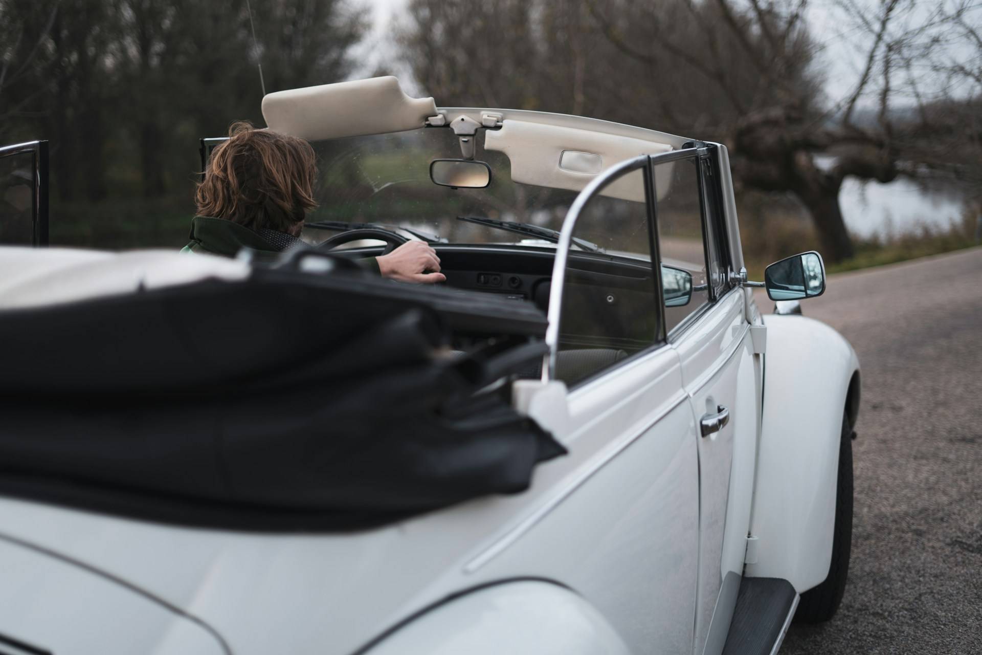 woman driving a convertible beetle