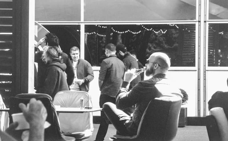 People gathered inside a modern building at night.