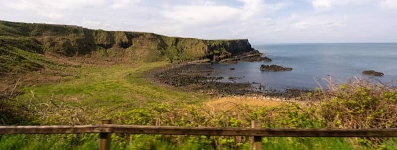 Coastal cliffs overlooking the sea under a cloudy sky