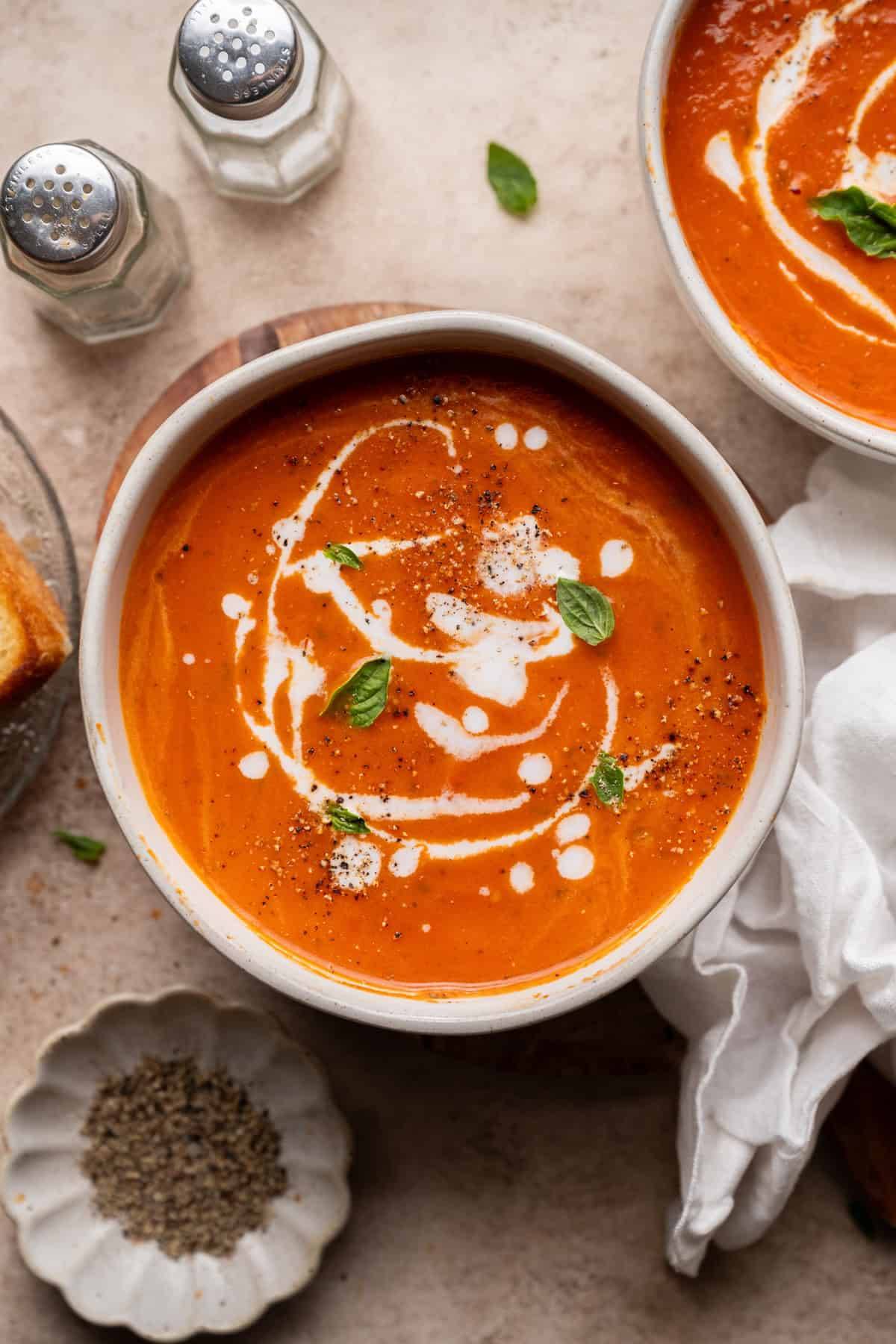 tomato soup topped with coconut milk and basil. 