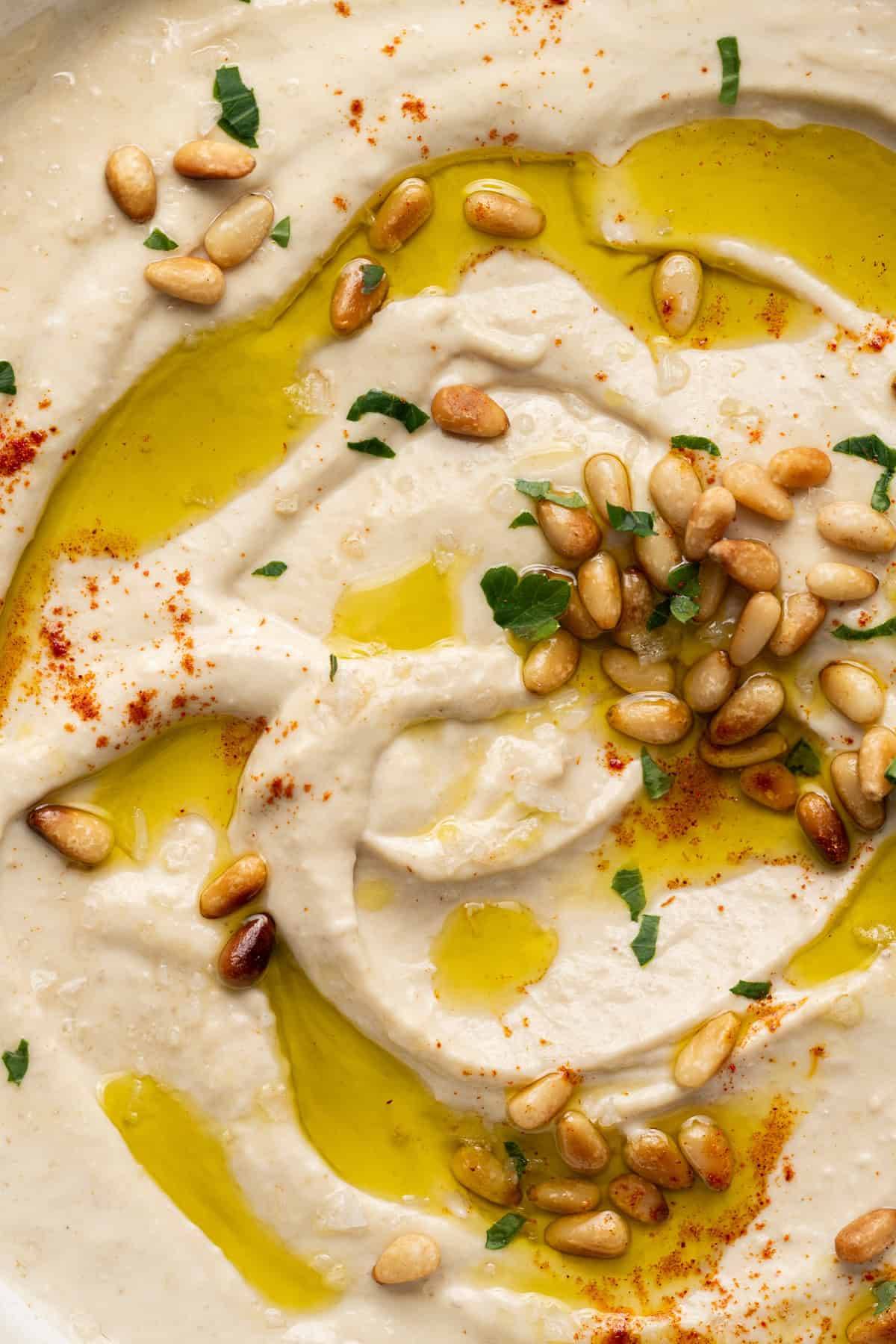 butter bean hummus topped with olive oil and pine nuts. 