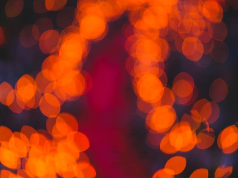 Abstract orange bokeh lights on dark background