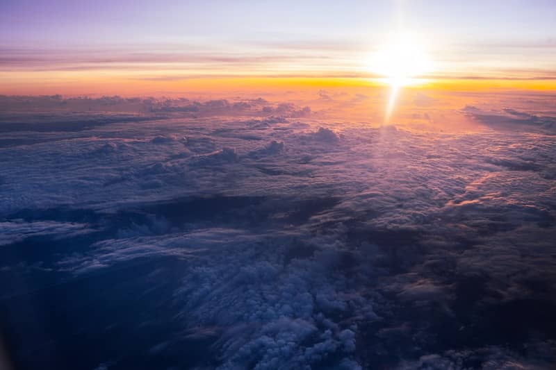 Sunrise over clouds seen from airplane window