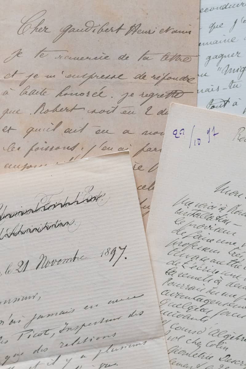 Vintage handwritten letters with elegant cursive script on aged paper.