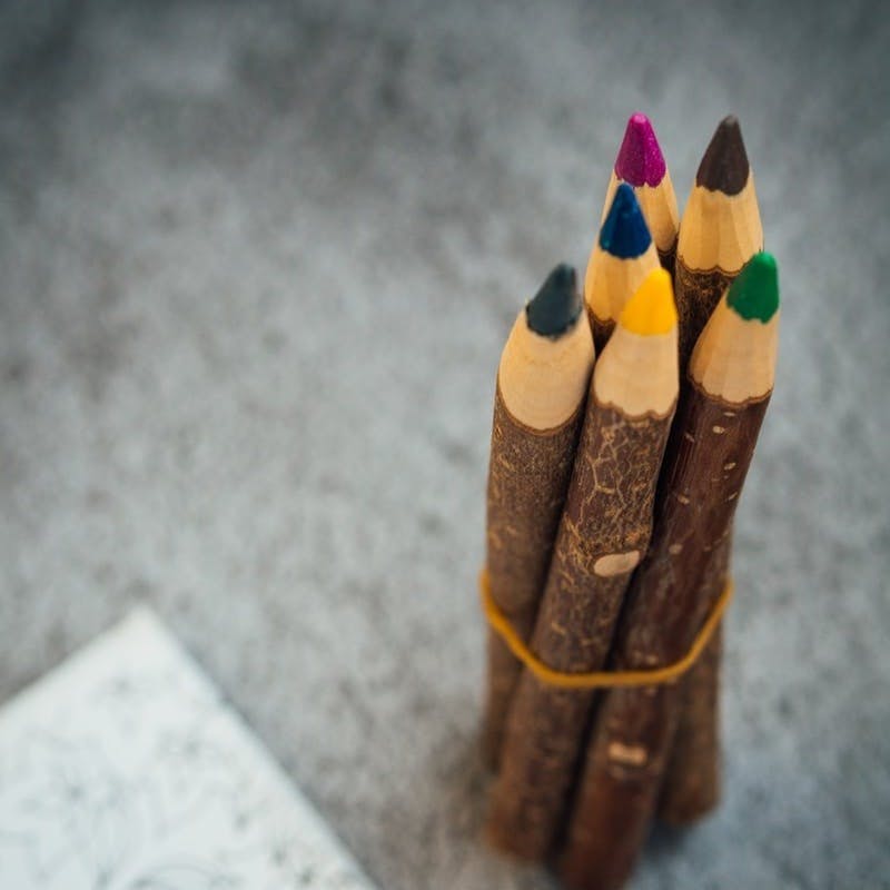 brown coloring pencils on gray surface
