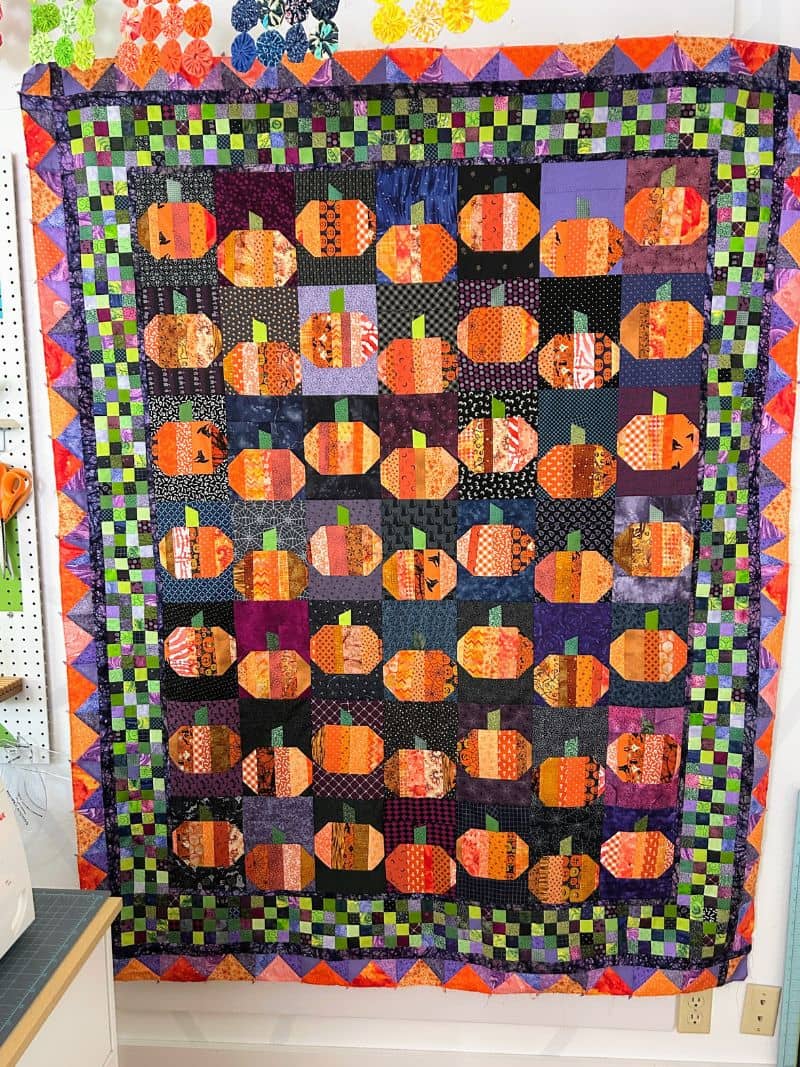 A string pieced pumpkin quilt with 4 borders. Pattern is Punkin' Patch by Bonnie K Hunter.