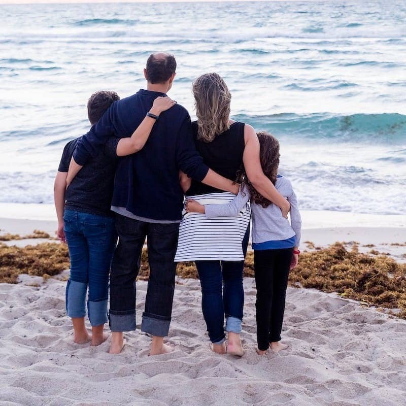 a family of four on a beach