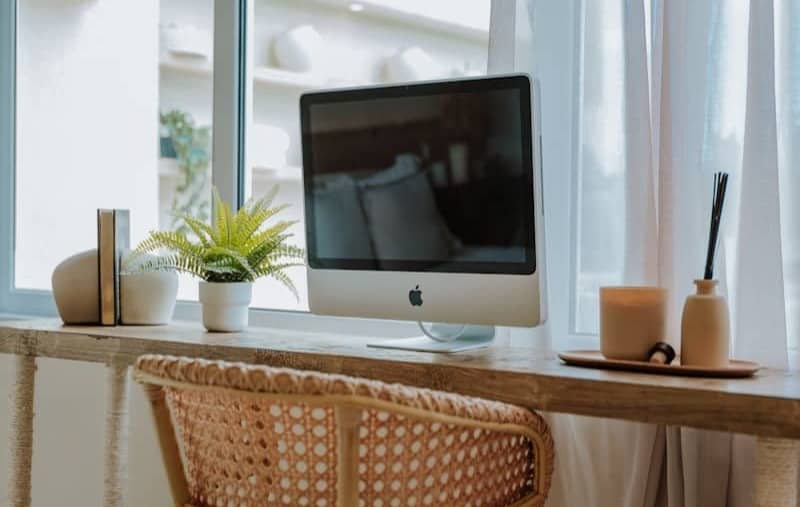 A minimalist workspace with computer and decor.