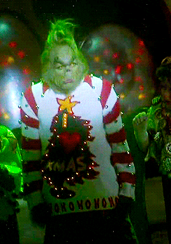 grinch wearing an I heart xmas shirt looking grumpy.