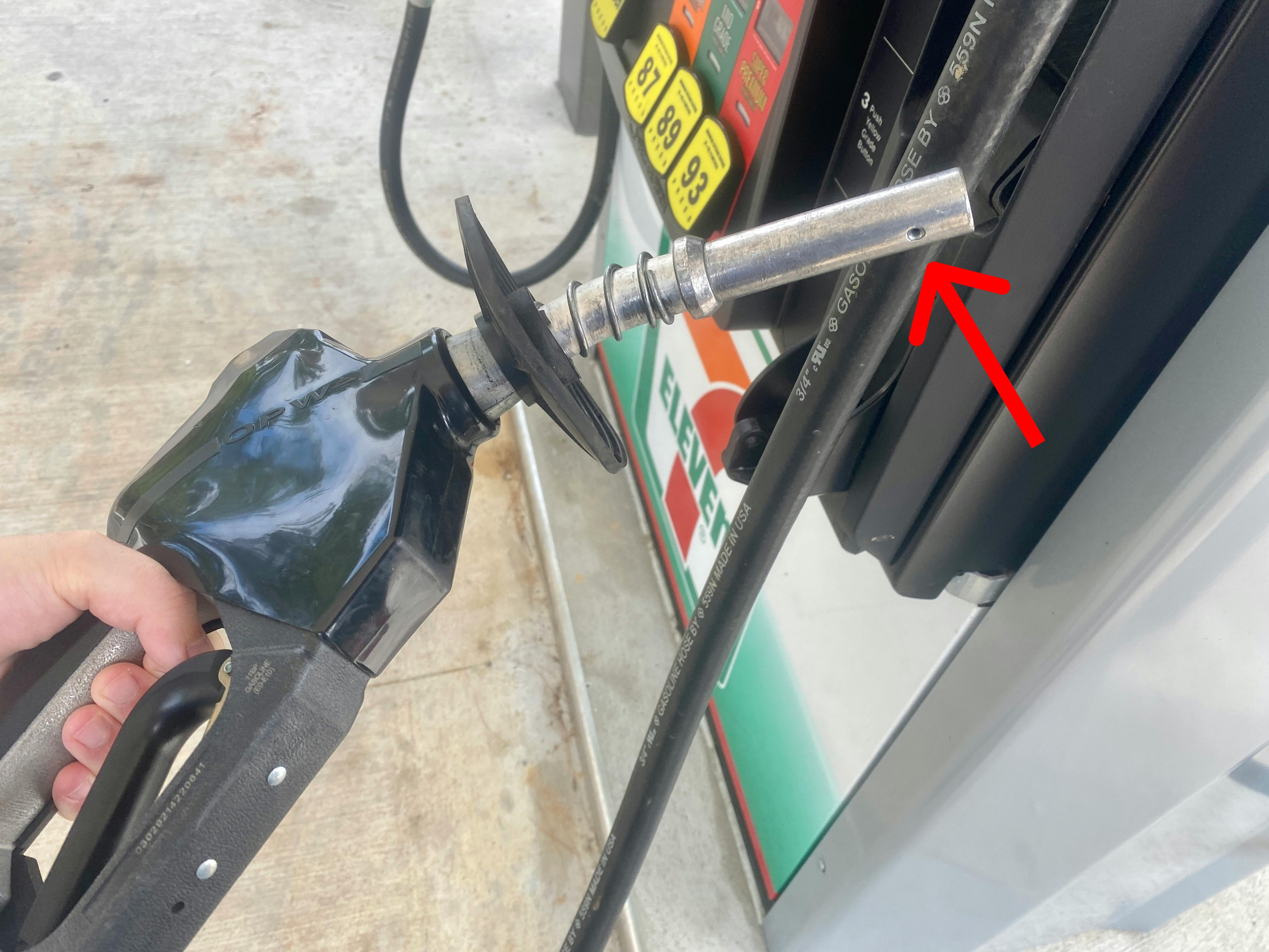 Image of a gas pump nozzle, showing the secret hole at the end of the nozzle.