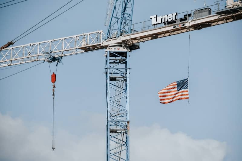 a large crane with a flag hanging off of its side