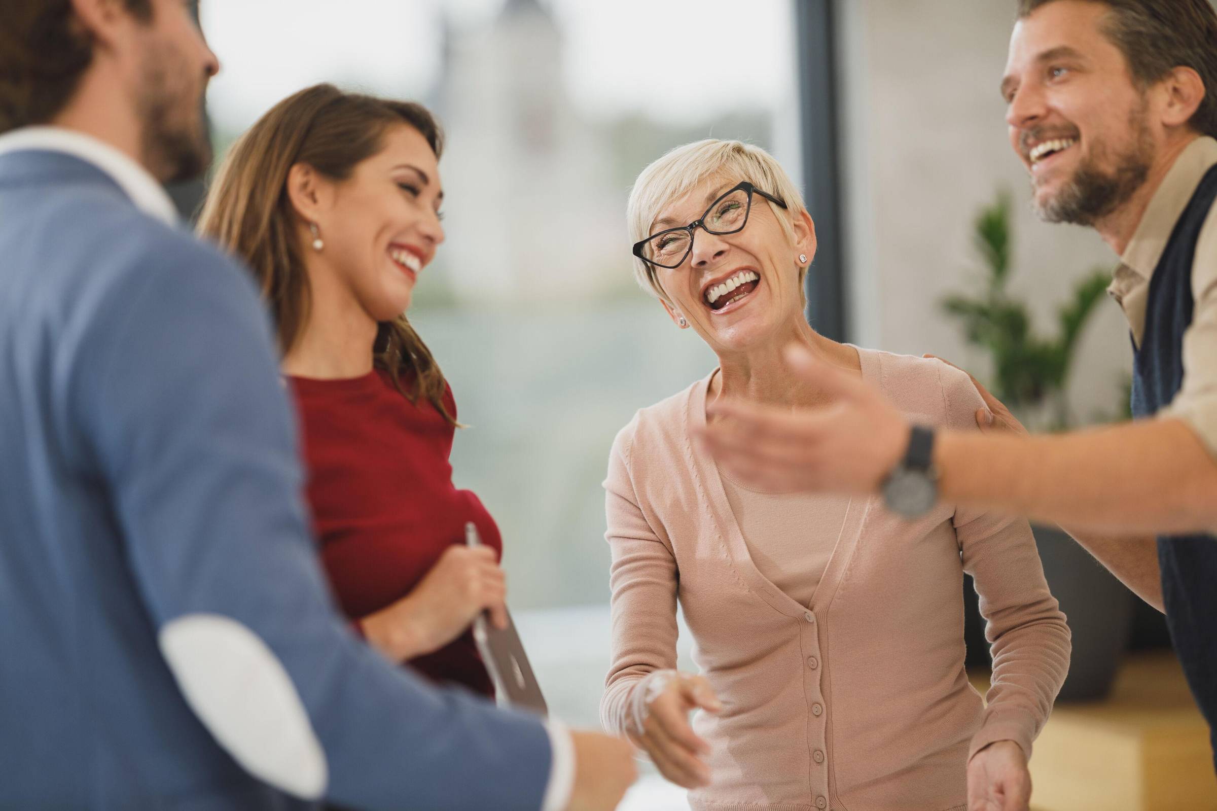 Stock image of a group of people laughing. 
