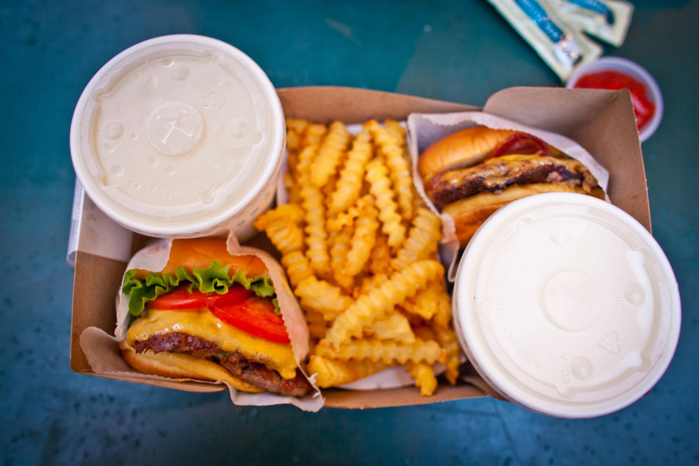 Image of burgers, fries, and milkshake. 