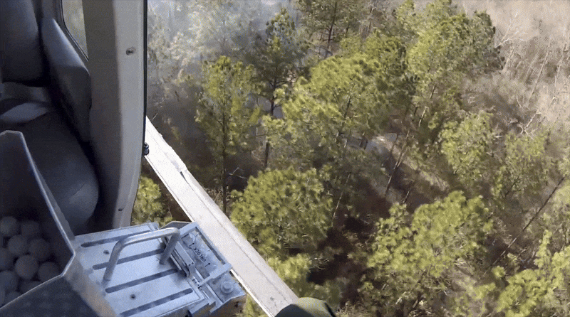 GIF showing aerial release of ignition dragon egg ping pong balls from a helicopter