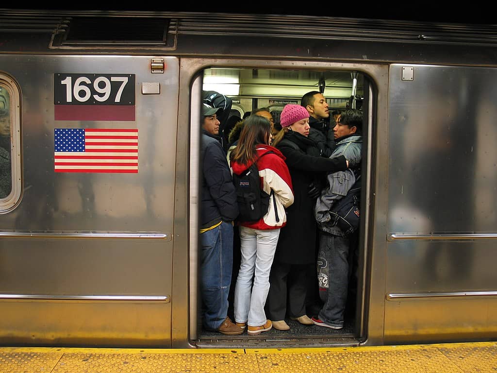 Crowded subway car of 7 train Queens bound late evening at 74th Street station.