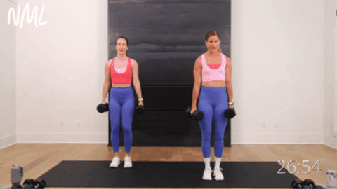 two women performing side to side squats as part of hiit workout routine for women