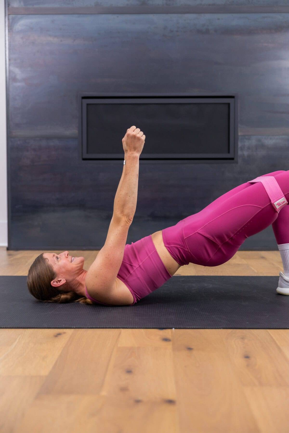 woman performing glute bridges as part of leg workout for bad knees