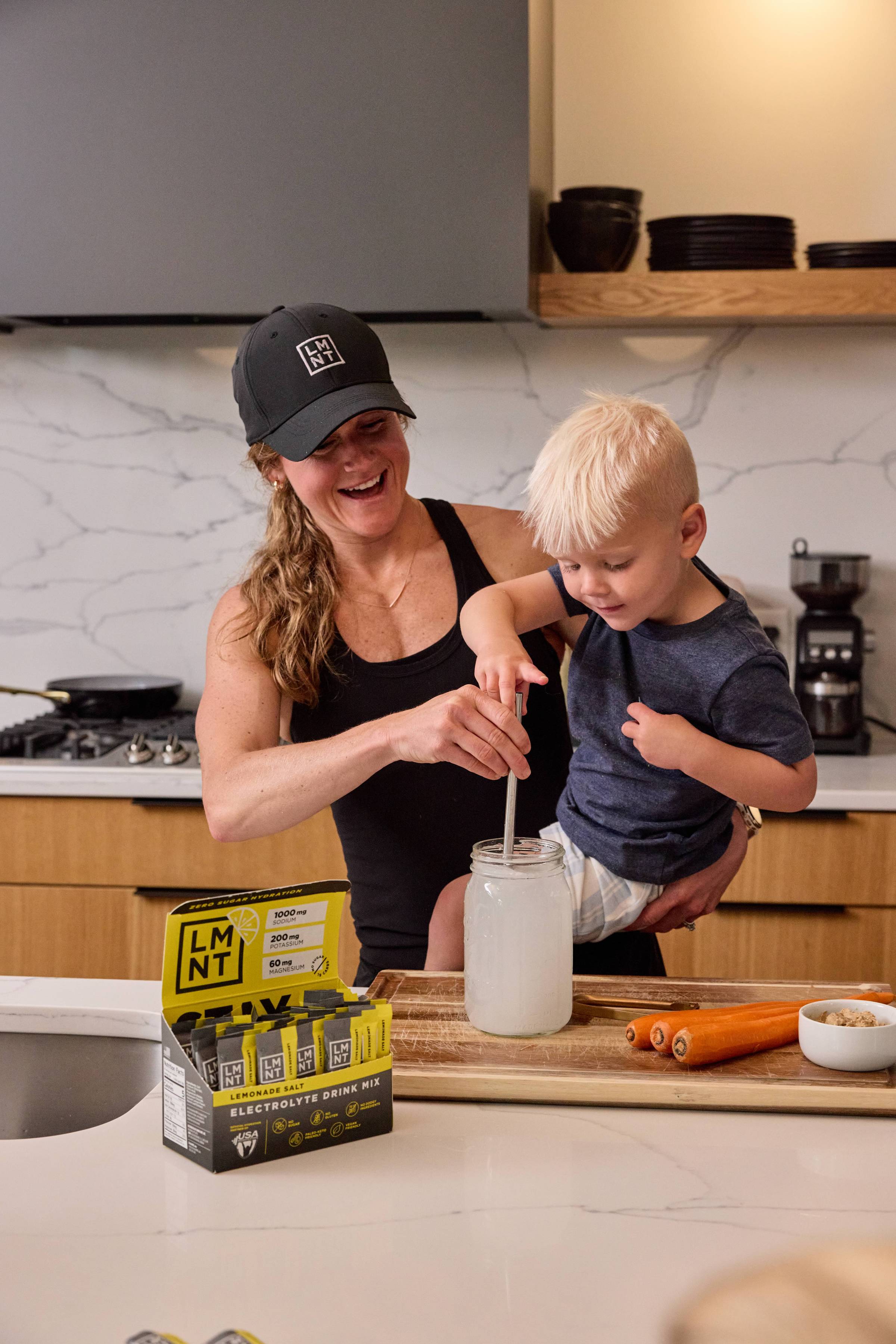 Lindsey pouring LMNT into a water bottle