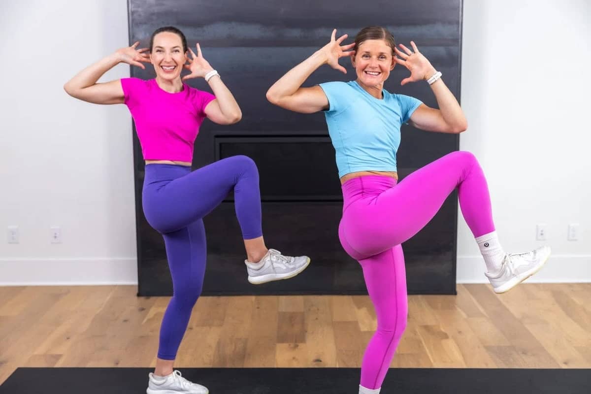 two women performing a standing crunch