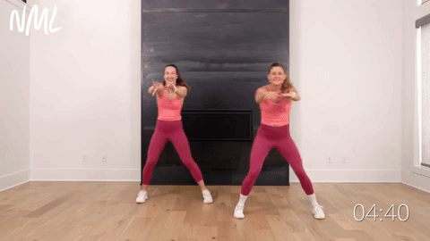 two women performing a side to side step touch in a walking workout