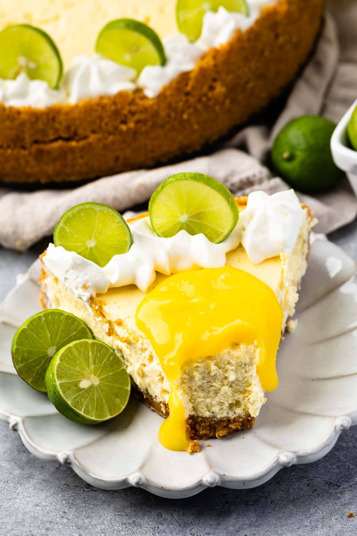 slice of cheesecake on plate with lime curd