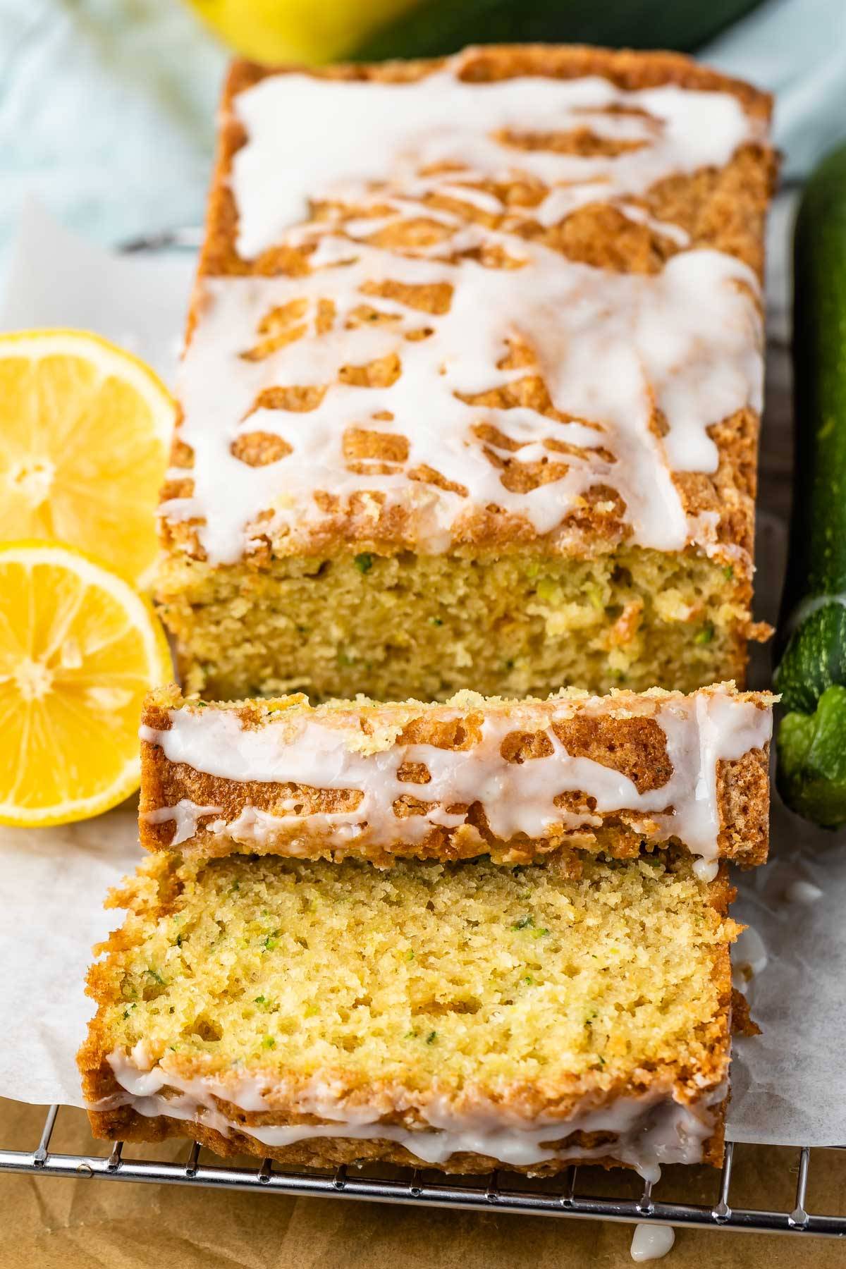 sliced lemon bread with zucchini baked in with glaze on top.