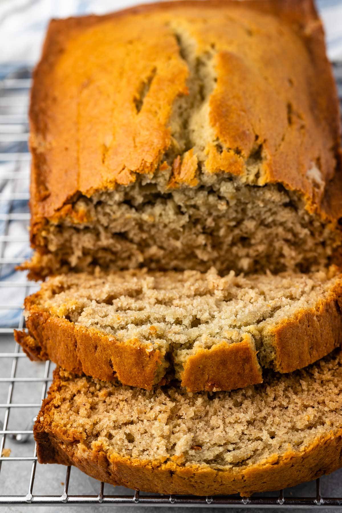 BANANA bread sliced on rack.