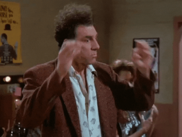 ID: GIF of Kramer character from Seinfeld making hand gesture that his mind is blown