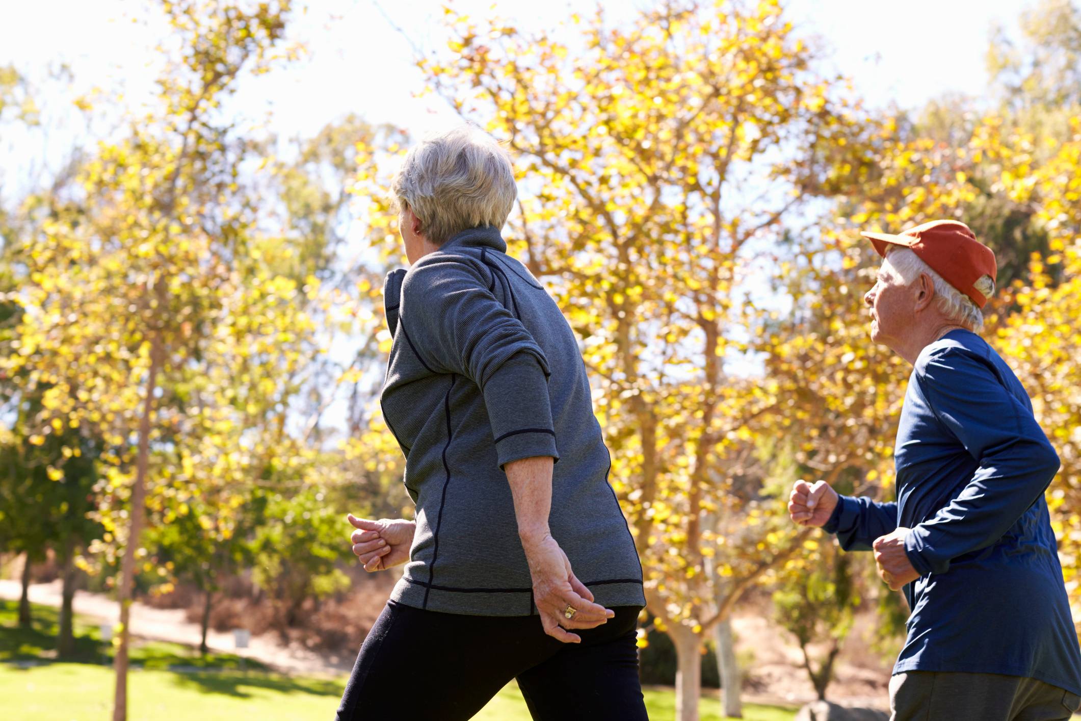 Rear view of older couple power walking