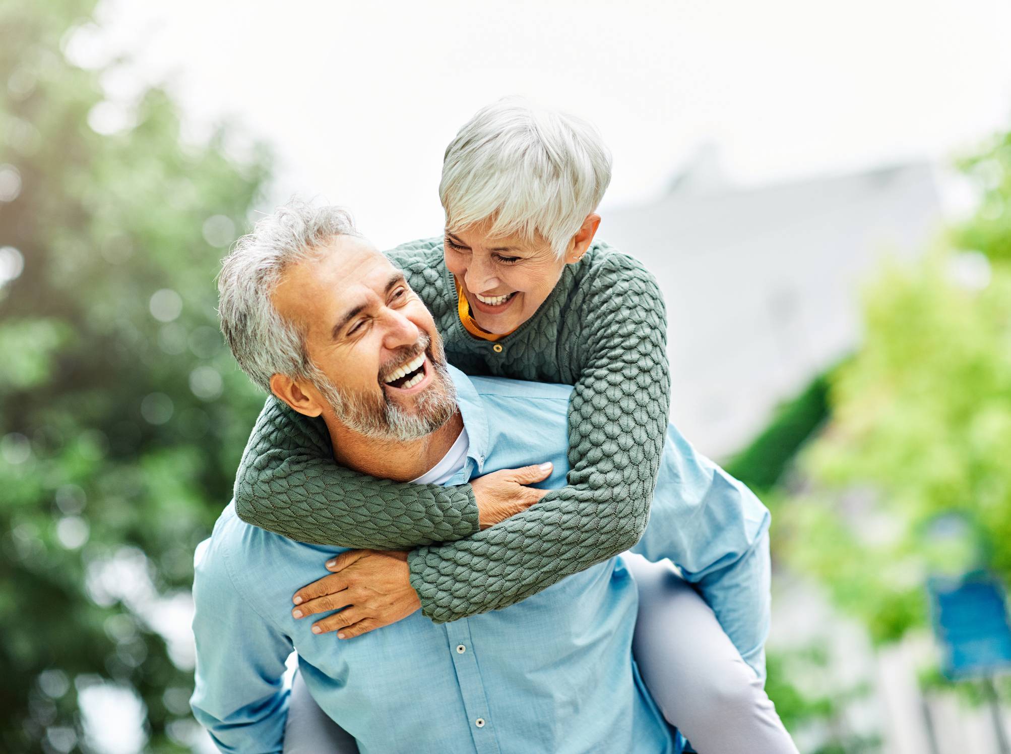Older couple with Woman Riding Piggyback