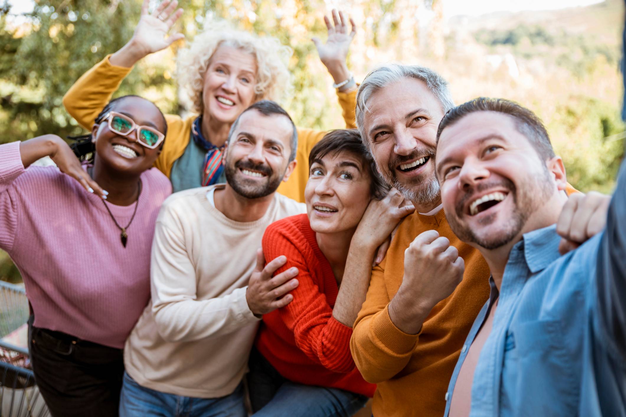 Older and young people smiling at camera