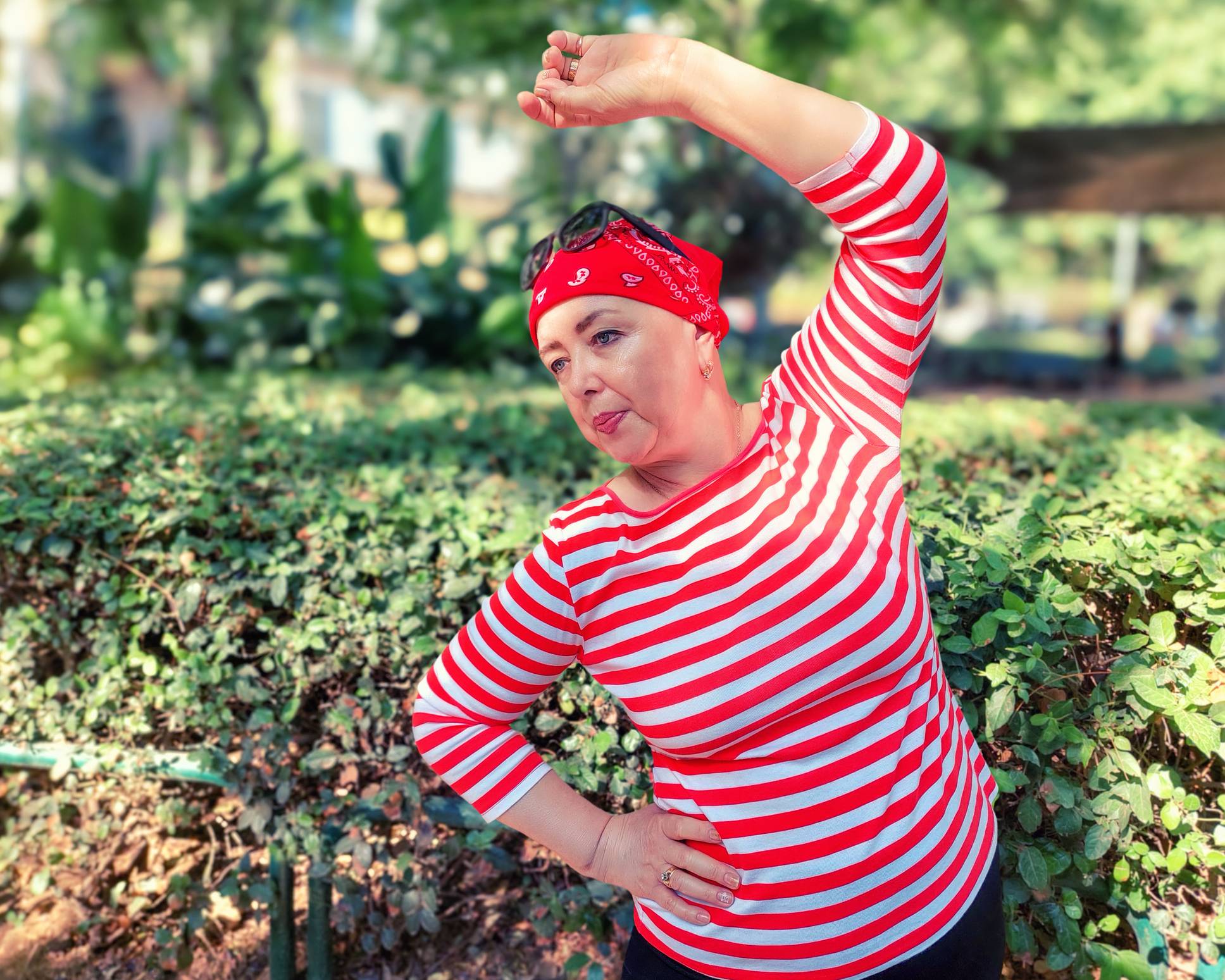 Senior woman with red bandana exercising in poark