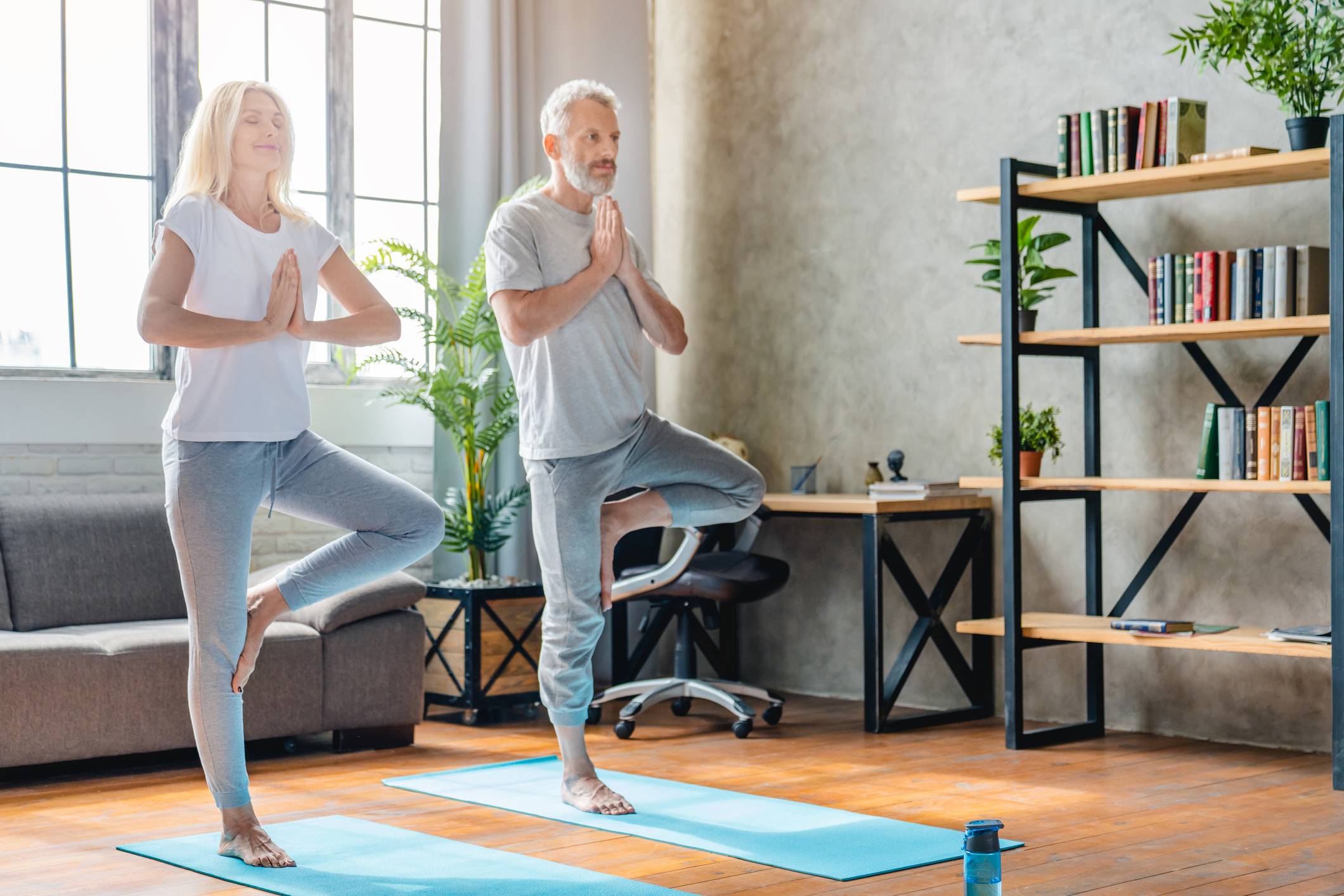 Older Couple performing Yoga Tree Pose