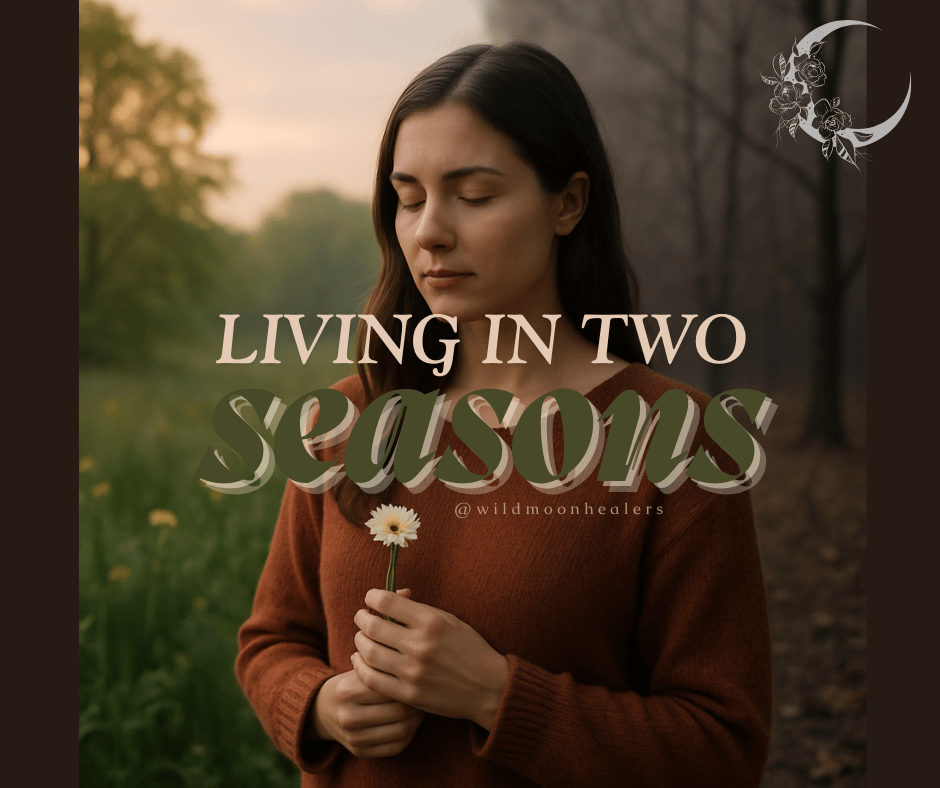 A woman with long dark hair stands in quiet reflection, eyes closed, holding a single white flower. She wears a rust-colored sweater and stands at the intersection of two landscapes—lush green spring on one side and barren winter trees on the other. Overl