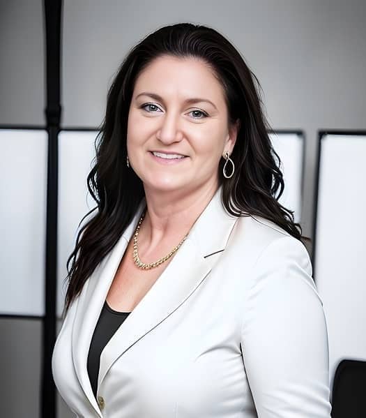 Headshot of Donna S Conley, Owner of Wild Moon Healers. She is wearing a white suite and in an office setting.