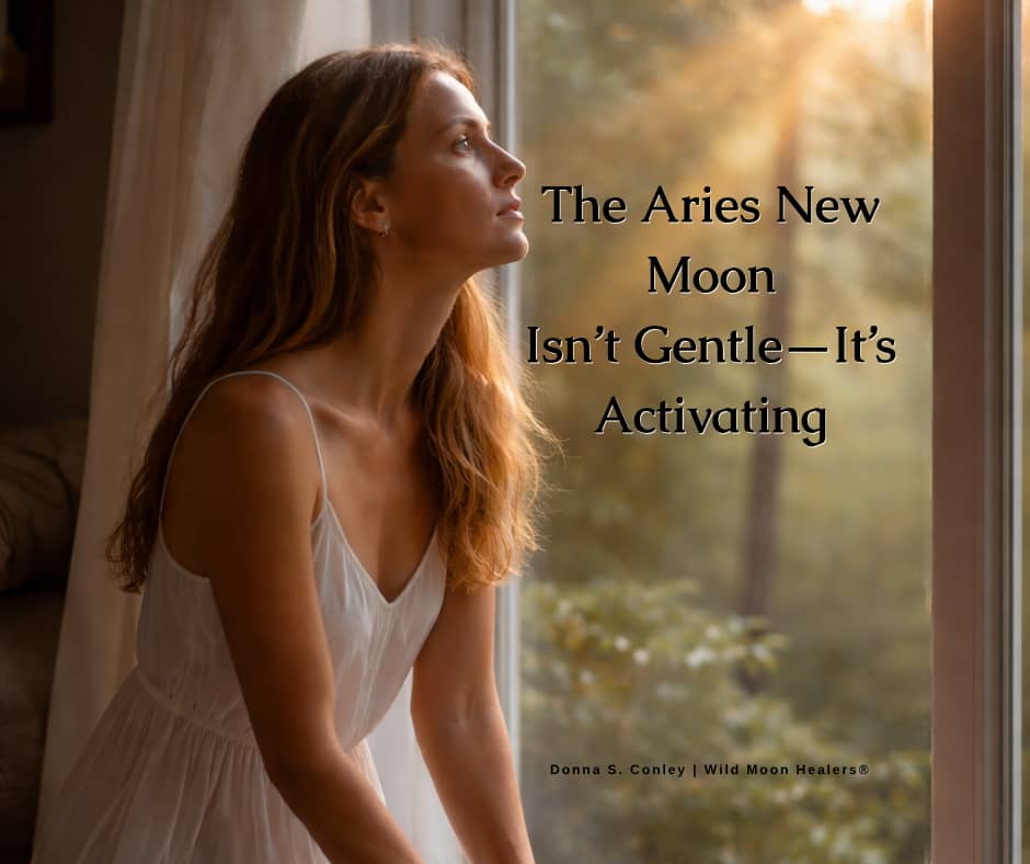 Woman looking out a window with text “The Aries New Moon Isn’t Gentle—It’s Activating,” representing a powerful energetic reset and new beginnings