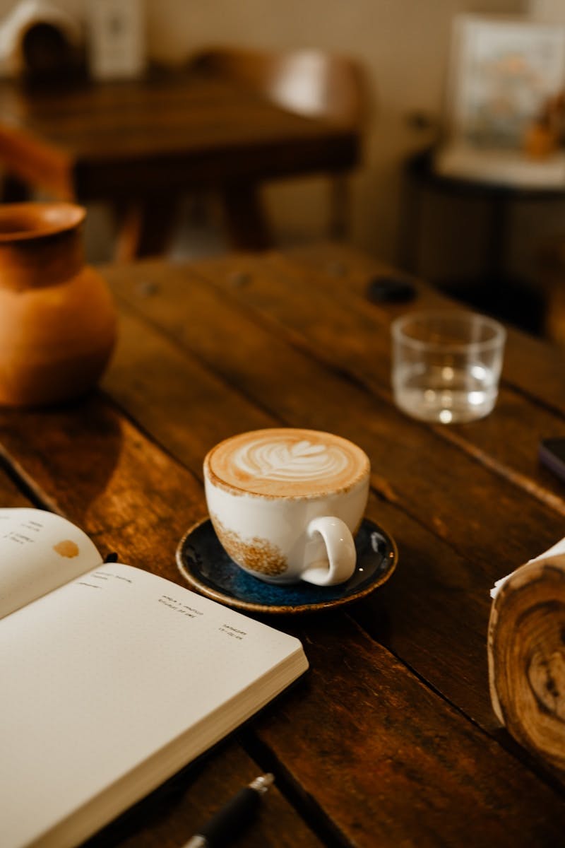 A cup of coffee sitting on top of a wooden table