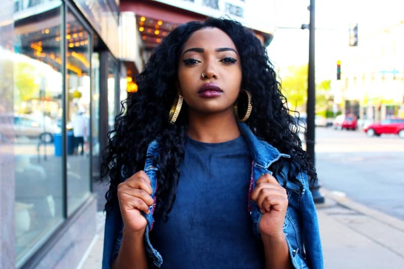 Black woman with long dark hair and big earrings
