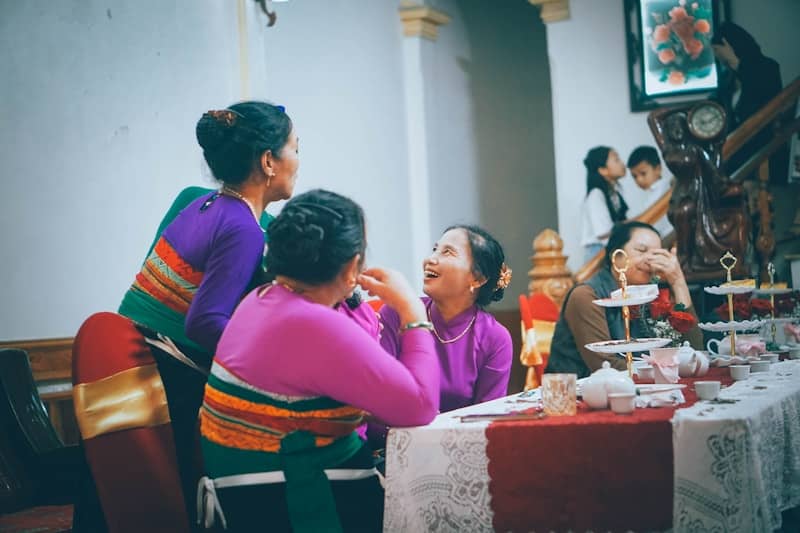 Women gathered around a table at a social event.