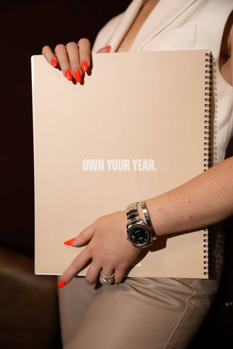 holding a book with text own your year