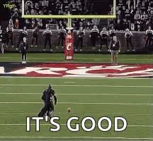 Someone dressed up as Batman makes a field goal.