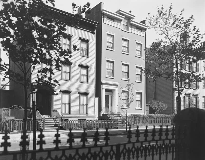 A black and white photo of a row of buildings