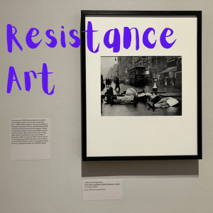 A black and white photograph of people lying in the road. The words Resistance Art in Purple over it.