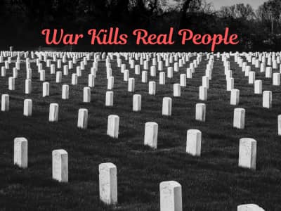 Many rows of white gravestones against green grass. The red words "War Kills Real People."