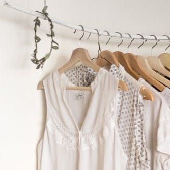 assorted clothes in wooden hangers