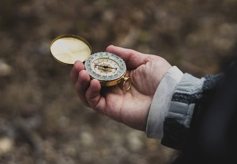 person using white and gold compass - Photo by Matt Perkins on Unsplash