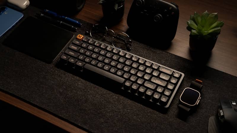 A computer keyboard sitting on top of a desk