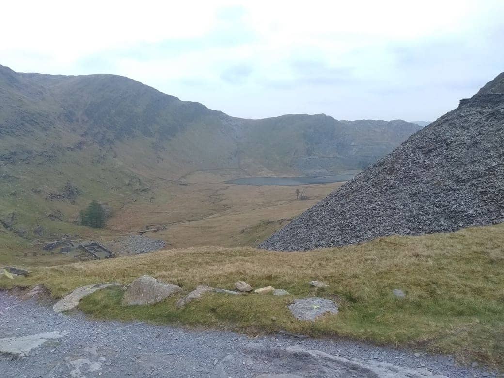  A view captured from the top of a hike, looking out over a landscape of peaks and valleys. This image signifies the triumph over challenges and the heights reached through resilience.