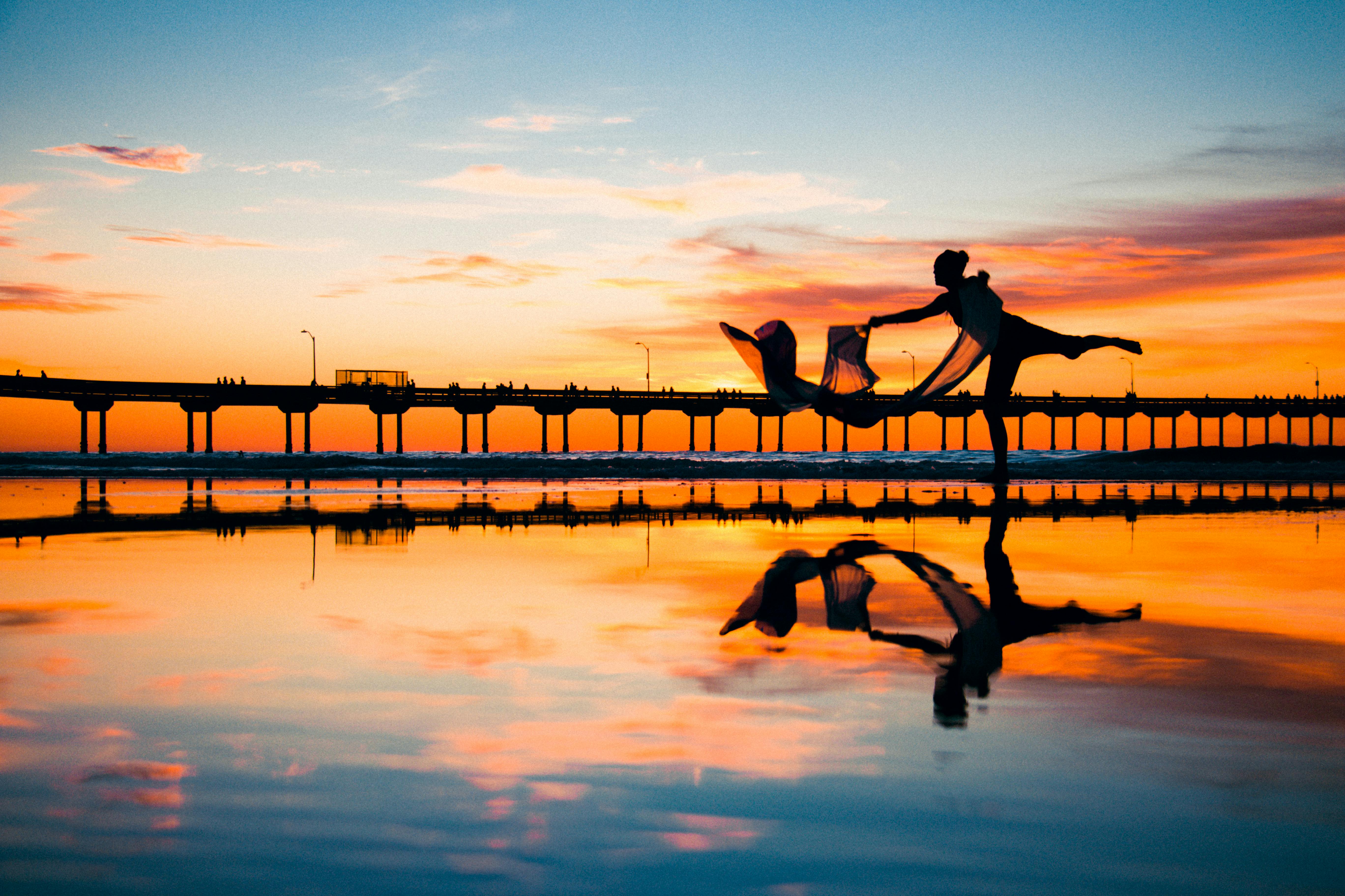 Woman dancing while the sun is setting